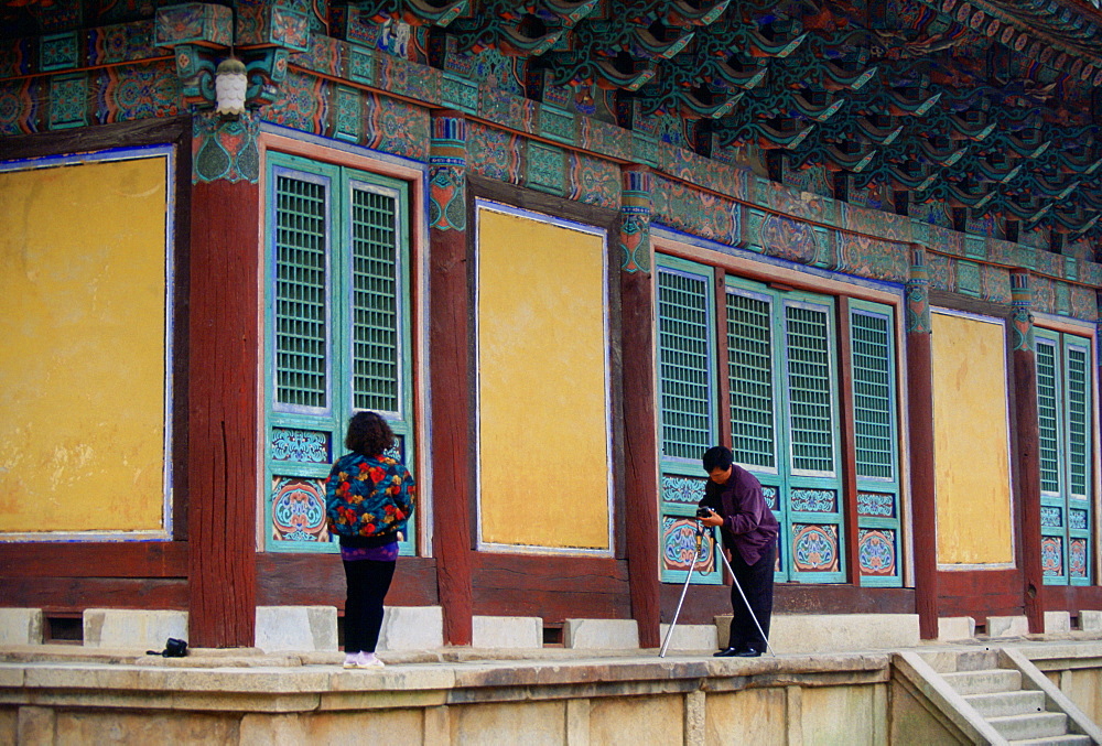 Tourists visiting the Pulguksa Temple in South Korea pause to take photographs of each other