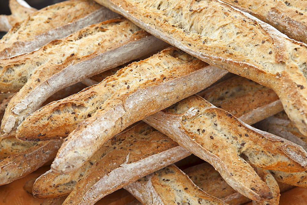 Freshly-baked multigrain 5 cereals French baguette bread on sale at food market at La Reole in Bordeaux region of France