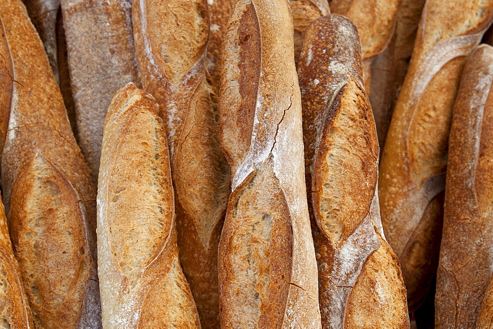 Freshly-baked French bread baguettes on sale at food market in Bordeaux region of France