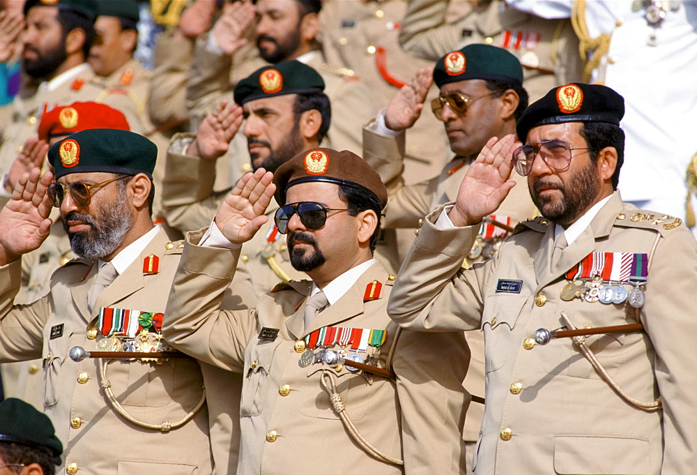 Military chiefs in uniform, with medals, saluting parade of armed forces in Abu Dhabi, United Arab Emirates