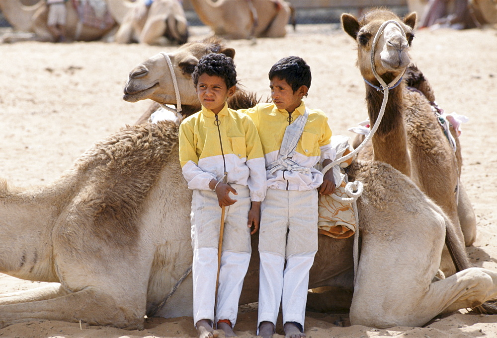 Camel racing boy jockeys at Al Ain in Abu Dhabi, United Arab Emirates, Middle East