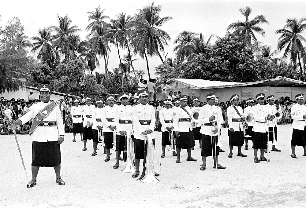 Soldiers in traditional uniforms wearing skirts in military parade in Kiribati, South Pacific