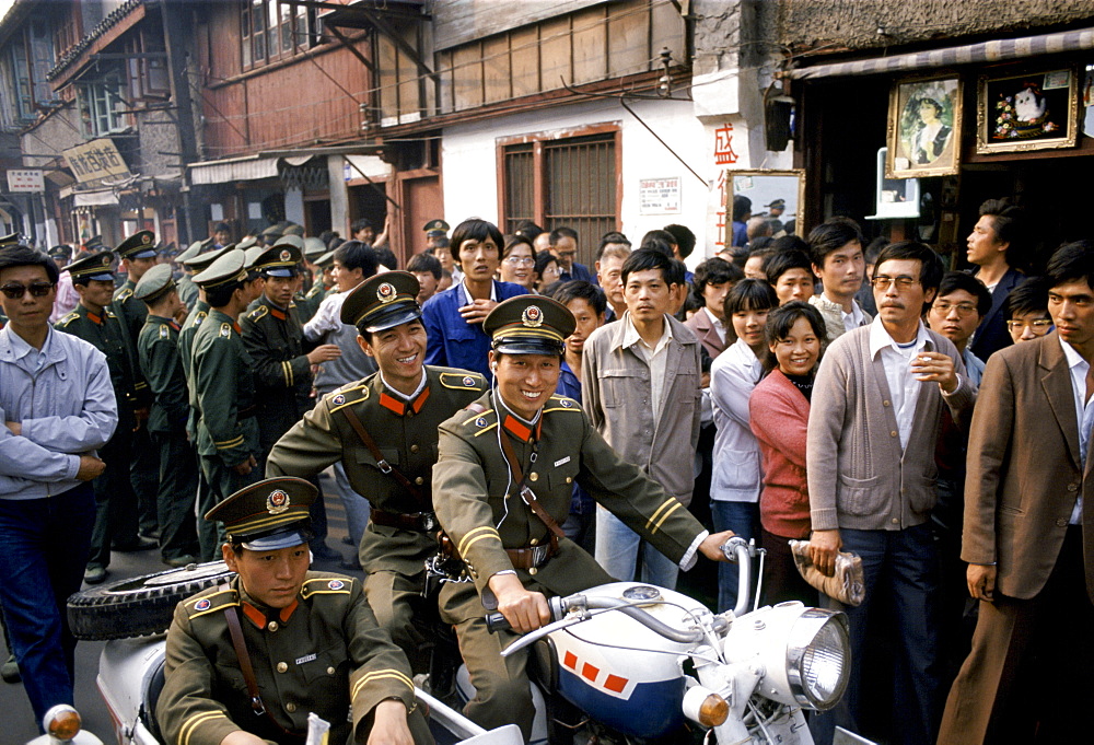 Army officers control crowd for VIP visit in Shanghai, China in 1980s