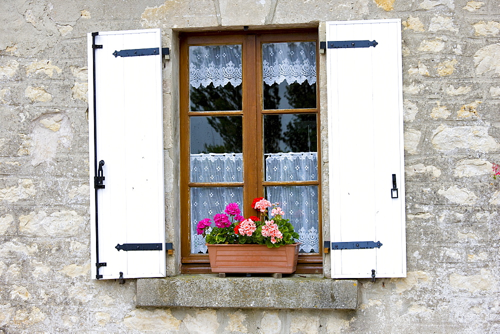 Typical French window with lace curtain and pelmet, window box and wooden shutters, Normandy, France