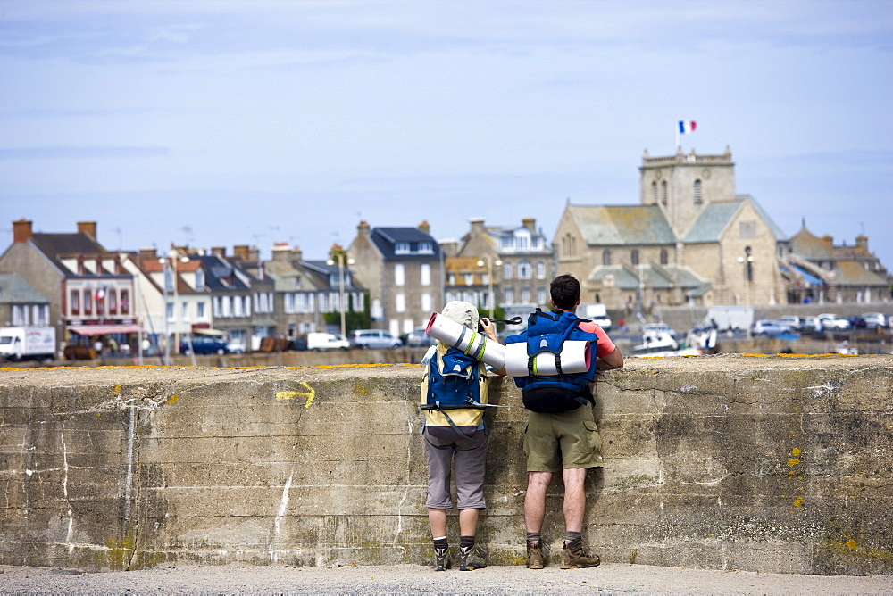 Tourist couple enjoying the view at Barfleur in Normandy, France