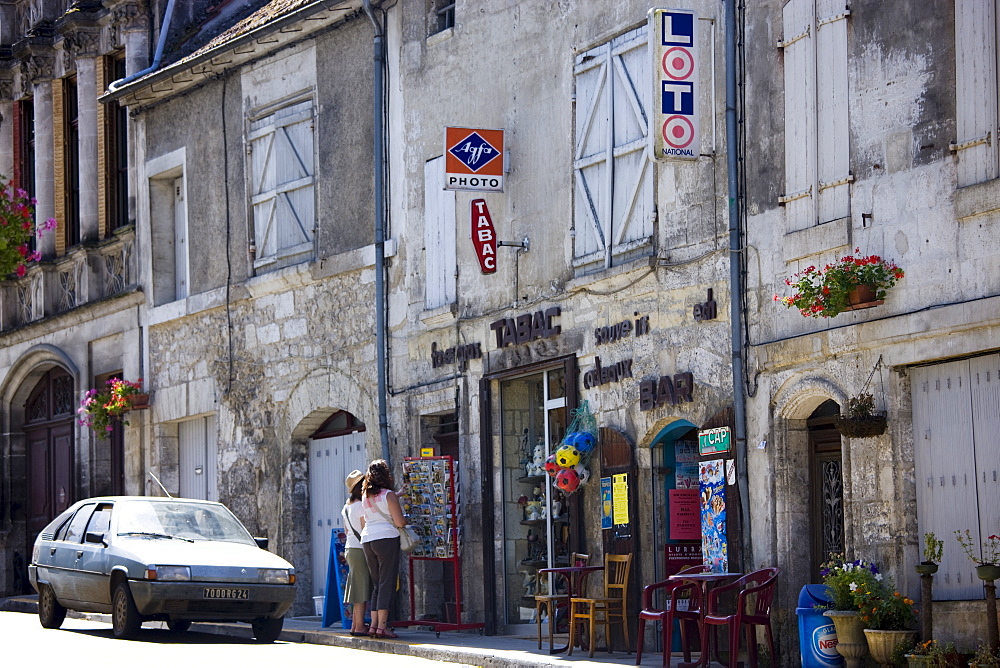 Tourists in quaint town of Bourdeilles popular tourist destination near Brantome North Dordogne, France