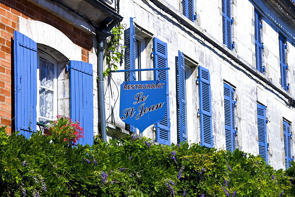 Restaurant Le St Jean, typical French restaurant with blue window shutters and sign in St Jean de Cole, The Dordogne, France