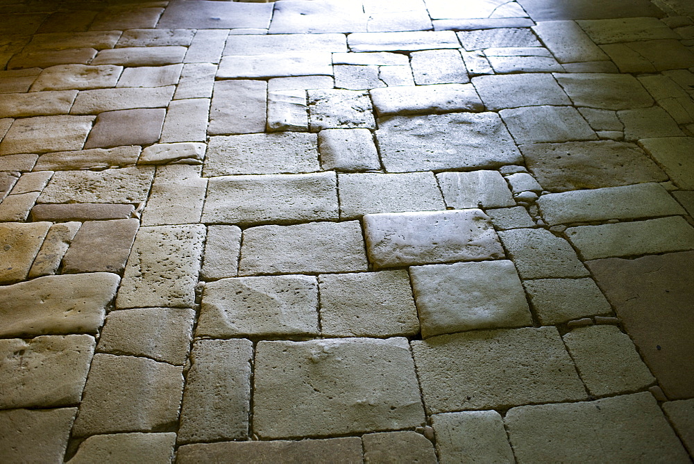 Old stone floor in the ancient church at St Amand de Coly in the Dordogne, France