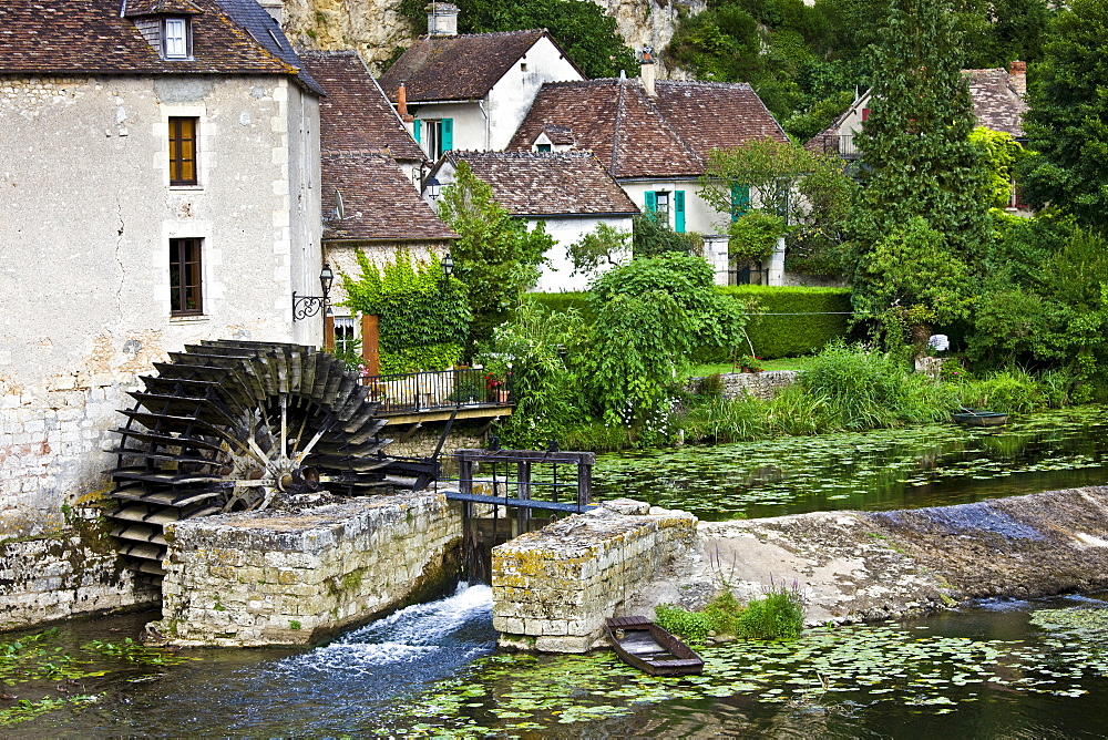 Traditional French houses, water wheel and millrace at Angles Sur L'Anglin medieval village, Vienne, near Poitiers, France