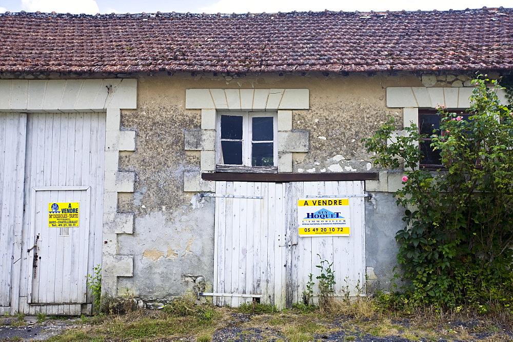 For Sale sign on period property for renovation at Serigny in the Loire Valley, France