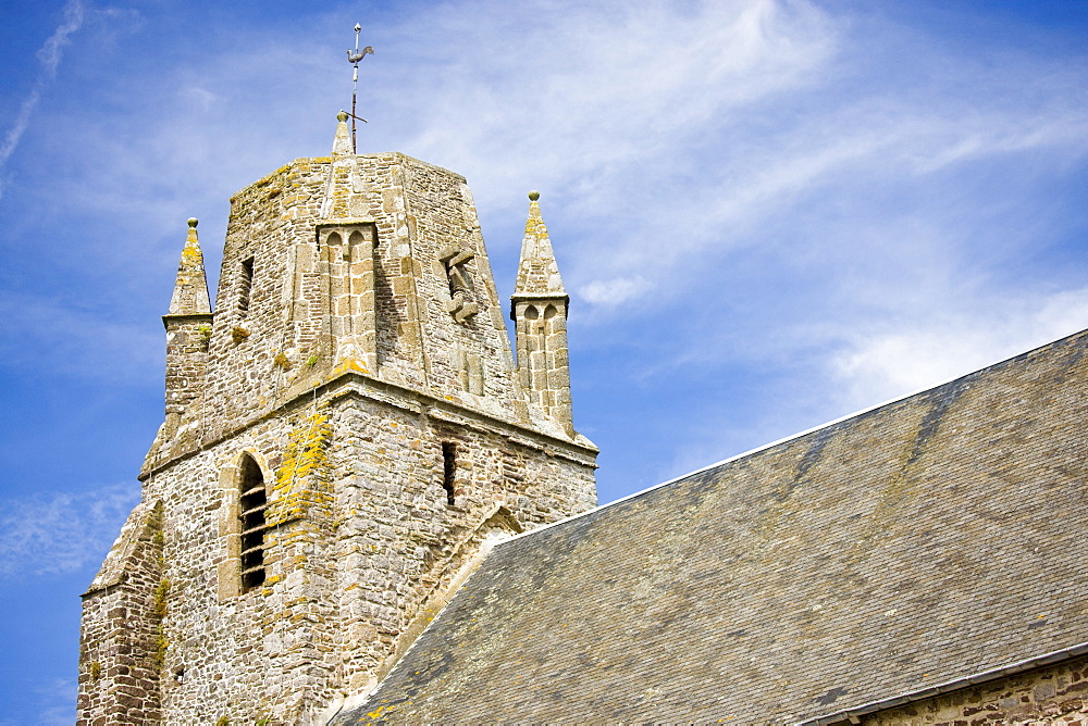 Norman church with unusual rounded square tower in Regneville-Sur-Mer in Normandy, France