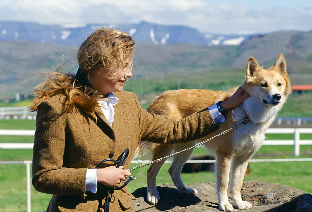 Woman with traditional Icelandic dog at Dalur, Iceland