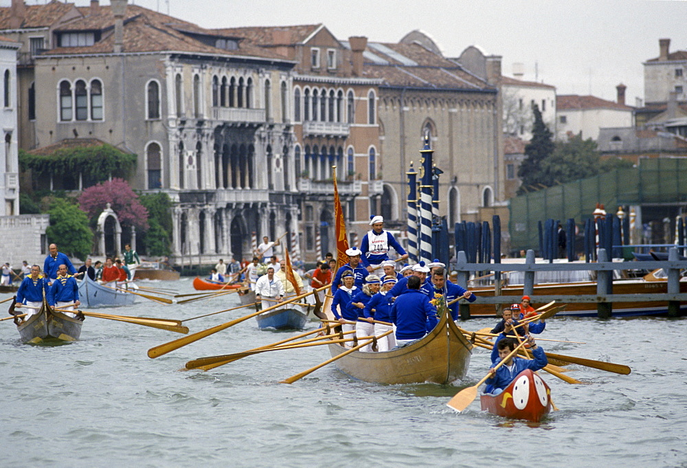 Traditional boating festival and carnival along canal in Venice, Italy