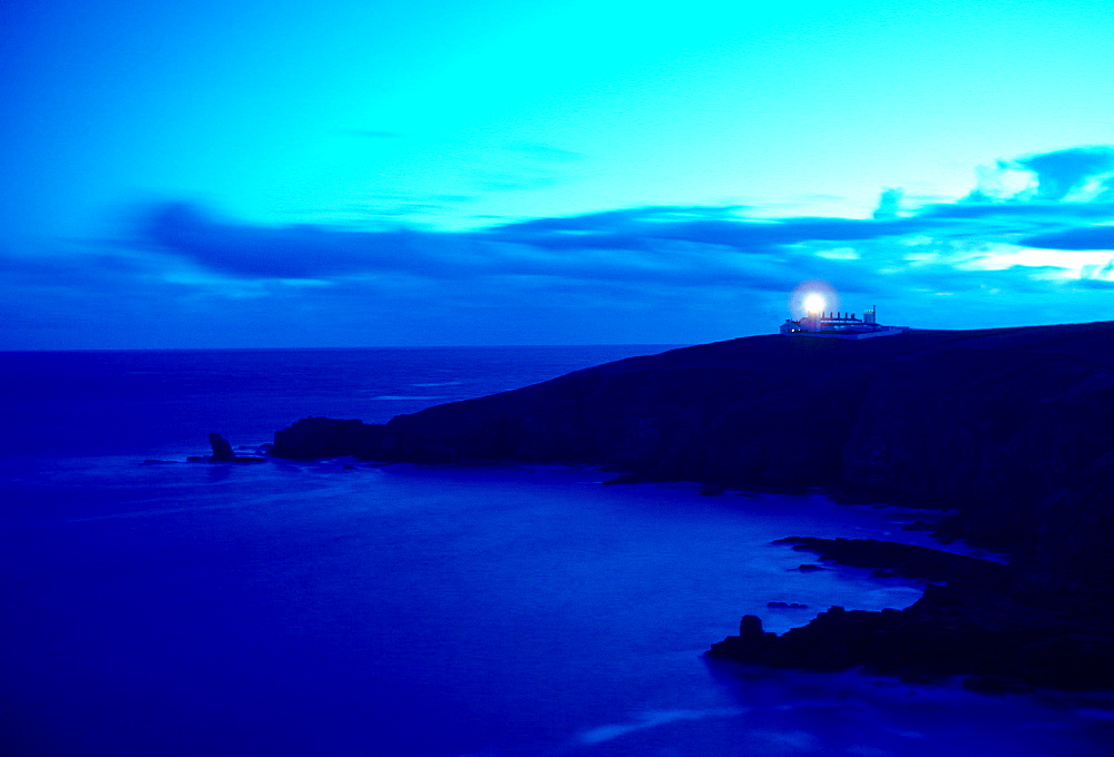 Lizard Point Lighthouse in Cornwall, England at dusk.