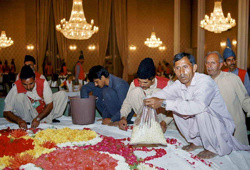 Making floral display of flower petals for celebration in Lahore, Pakistan