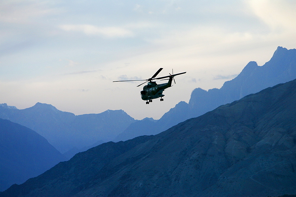 Military Helicopter in flight in Hunza region of Karokoram Mountains, Pakistan