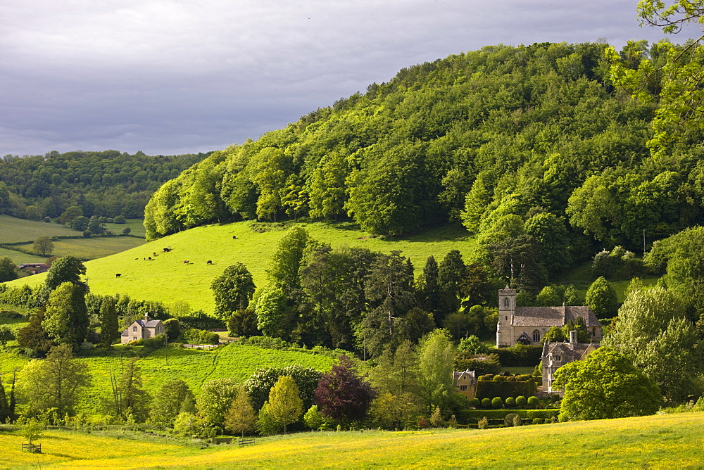 Typical idyllic countryside landscape rural scene in The Cotswolds Owlpen manor and Church, Gloucestershire, UK