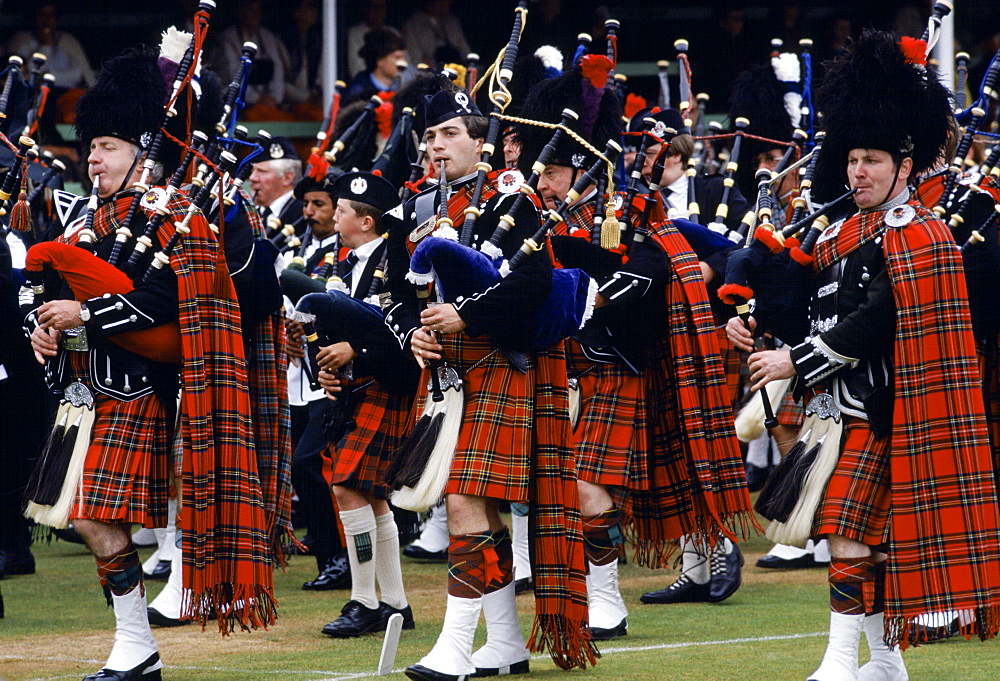 Traditional Scottish band in tartan kilts marching at the Braemar Royal Highland Gathering, the Braemar Games in Scotland