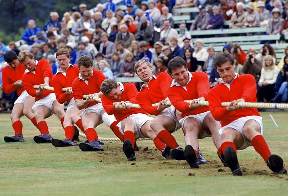 Scottish men taking part in traditional tug of war, tug o' war, at the Braemar Royal Highland Gathering, the Braemar Games in Scotland