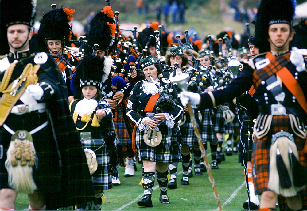 Traditional Scottish band in tartan kilts marching at the Braemar Royal Highland Gathering, the Braemar Games in Scotland