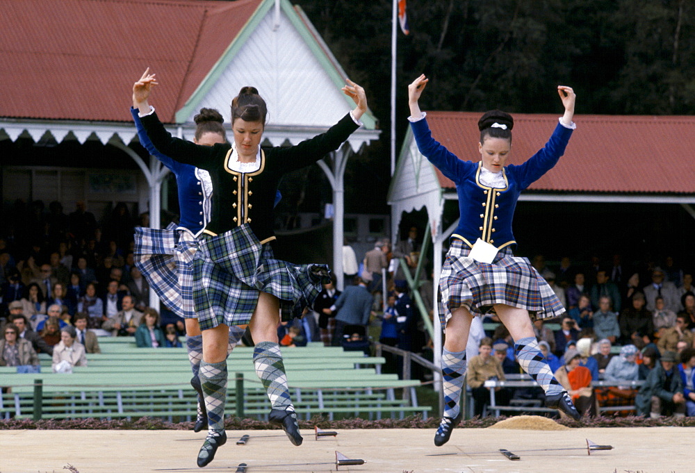 Scottish girls in tartan kilts dancing the sword dance at the Braemar Royal Highland Gathering, the Braemar Games in Scotland