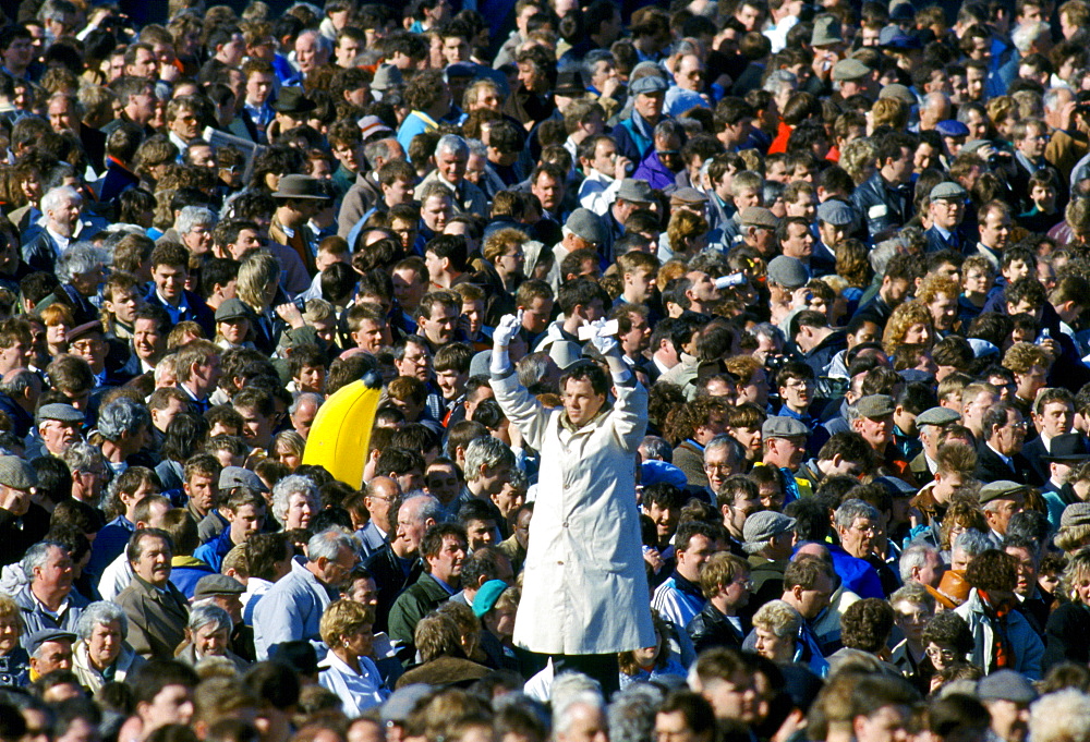 Tic-Tac man with white gloves and old method signals bookmakers odds for betting at Cheltenham Racecourse National Hunt Festival of Racing, UK