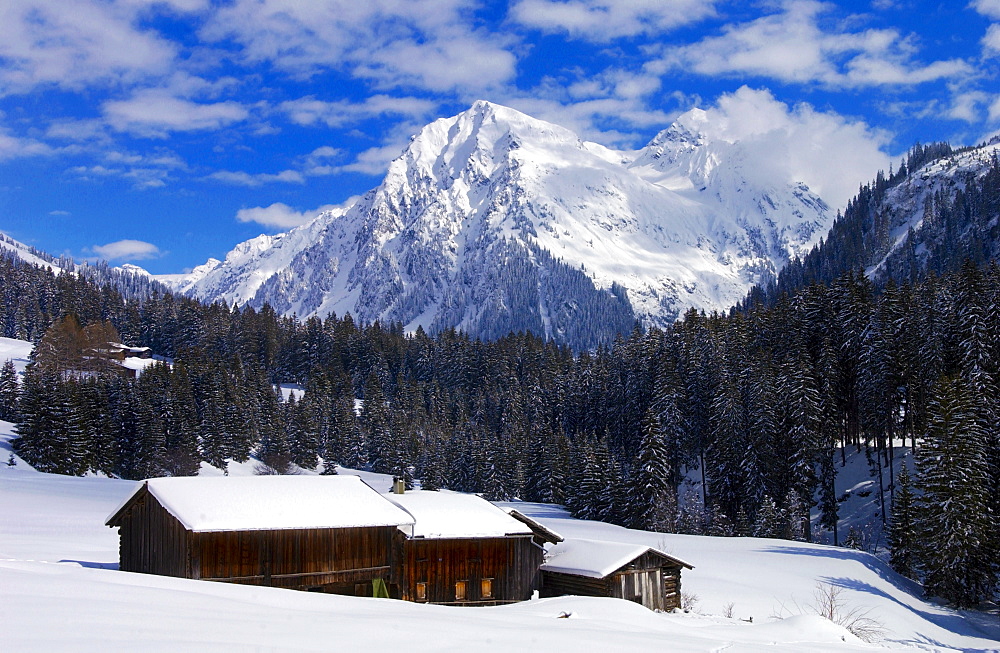 Farmhouse  and barn at Klosters - Amongst the Silvretta group of the Swiss Alps. Road to Silvretta.Mountain at right is P.Linard 3411 metres high