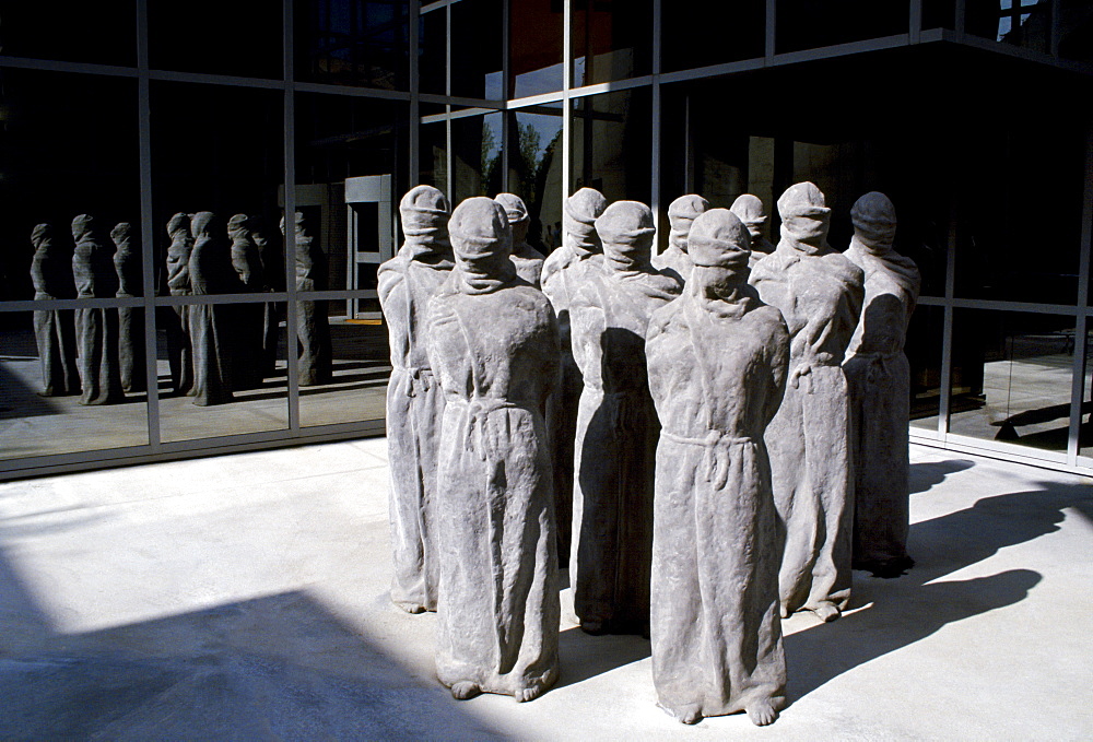 The "Petrified" a group of shrouded, life-size figures by Swiss artist Carl Bucher denouncing the violation of human rights at the entrance of the Museum of the International Red Cross in Geneva, Switzerland