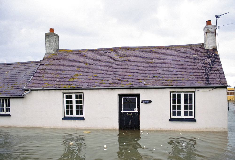 Flood disaster as homes are surrounded by deep flood water at Towyn in North Wales in 1990, UK