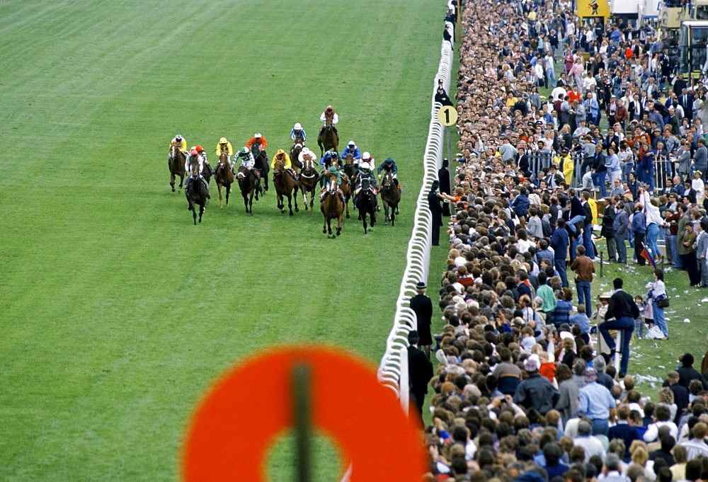 Crowds of spectactors by winning post at the racetrack at Epsom Racecourse for Derby Day, UK