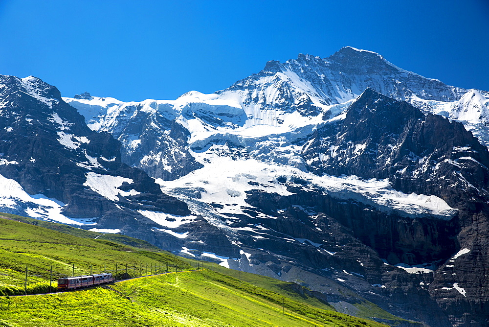 Jungfraubahn funicular train climbs to the Jungfrau from Kleine Scheidegg in the Swiss Alps in Bernese Oberland, Switzerland, Europe