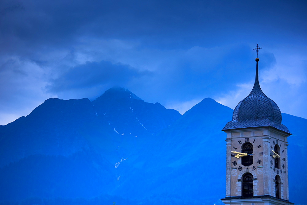 Nighttime scene of traditional church in the Swiss Alps, Graubunden region of Eastern Switzerland, Europe