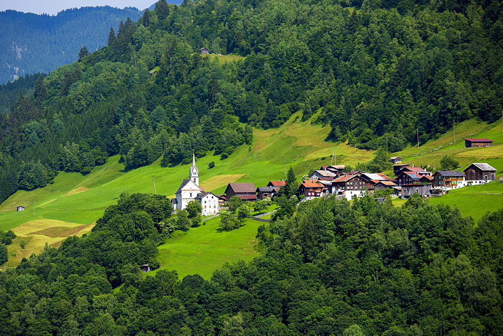 Church and village of Surrein in mountain pass in the Graubunden region of Switzerland, Europe