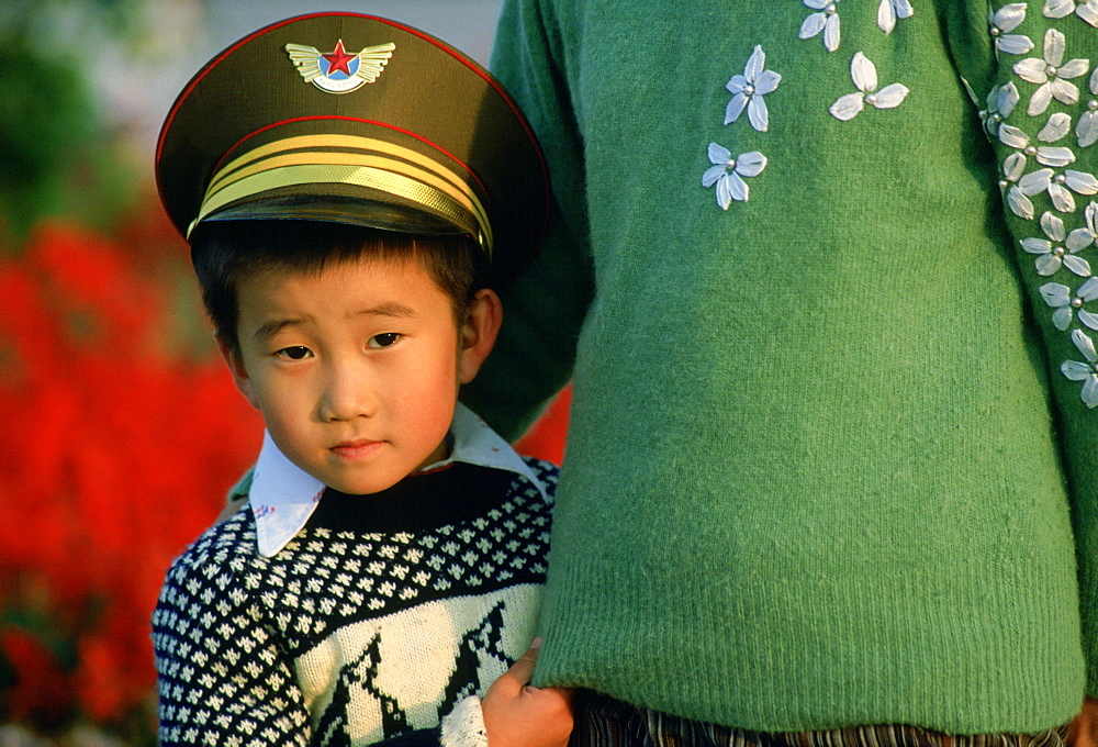 Boy in China wearing khaki army hat, Beijing, China