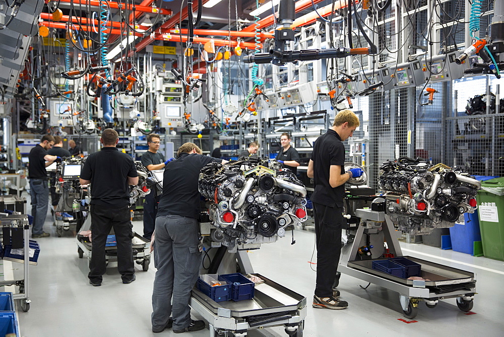 Engineers at work each hand-building an M157 5.5L V8 biturbo engine, Mercedes-AMG engine production factory in Affalterbach, Bavaria, Germany, Europe