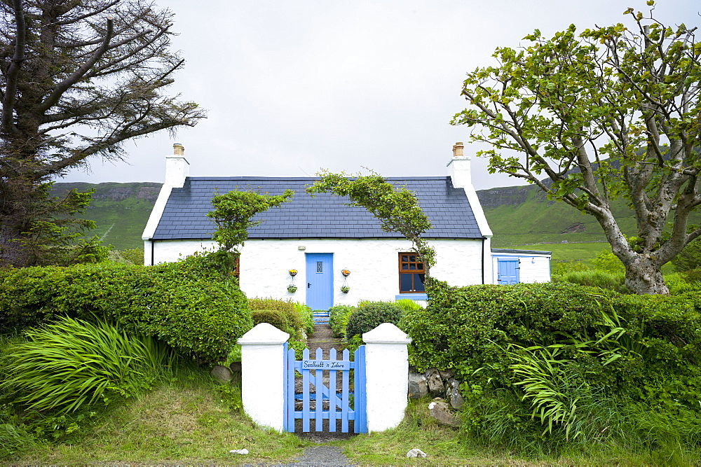 Quaint traditional Highland cottage in patriotic blue and white colours to match Scottish flag, near Linicro in the Highlands of Scotland, United Kingodm, Europe