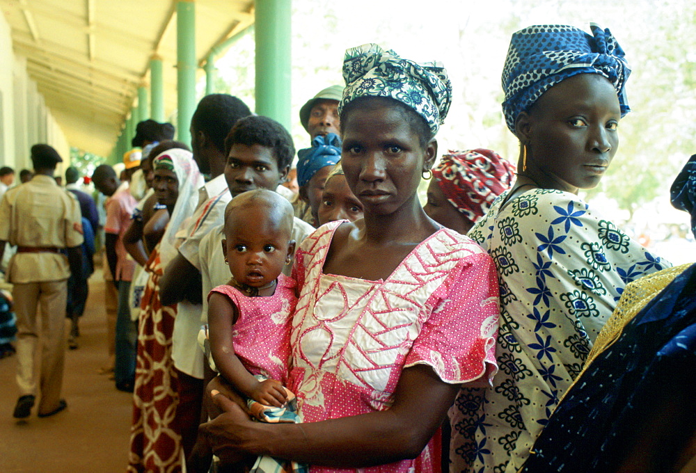 Women queuing with their children at the rural hospital at Basse in Gambia