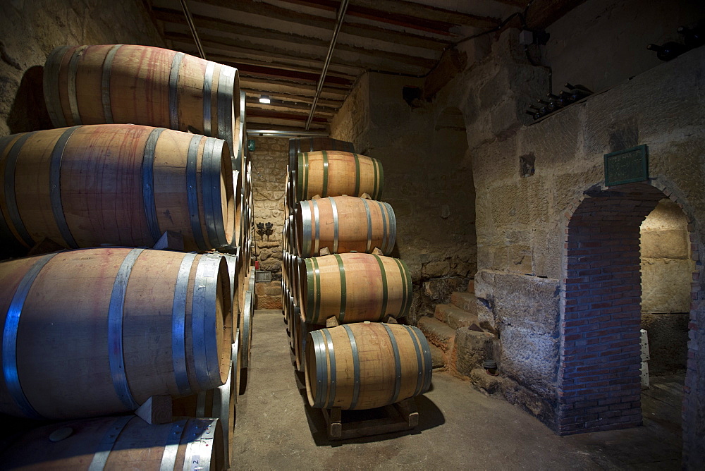 Rioja wine in American oak barrels in cave at Bodegas Agricola Bastida in Rioja-Alavesa area of Basque country, Euskadi, Spain. Europe