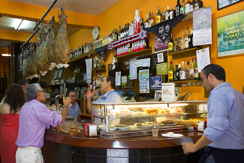 Locals in traditional Spanish tapas raciones Bar Restaurante Bikandi in central Bilbao, Euskadi, Spain, Europe