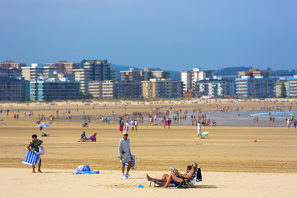 Beach scene and people sunbathing on summer holiday in Laredo, Cantabria, Spain, Europe