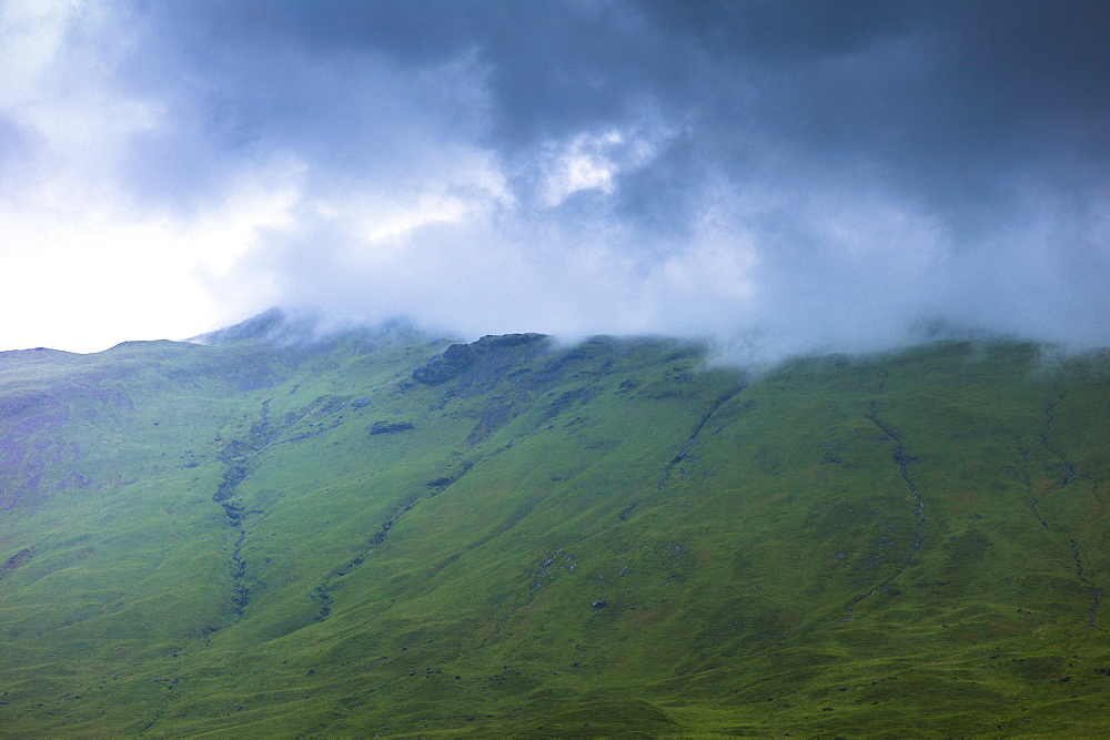 Low dark grey clouds tumbling over mountains on Isle of Mull, Inner Hebrides and Western Isles, Scotland, United Kingdom, Europe