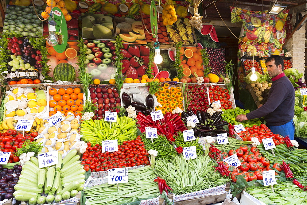 Shopkeeper with fresh fruit and vegetables with Turkish lira prices at food market Kadikoy, Asian Istanbul, Turkey, Asia Minor, Eurasia