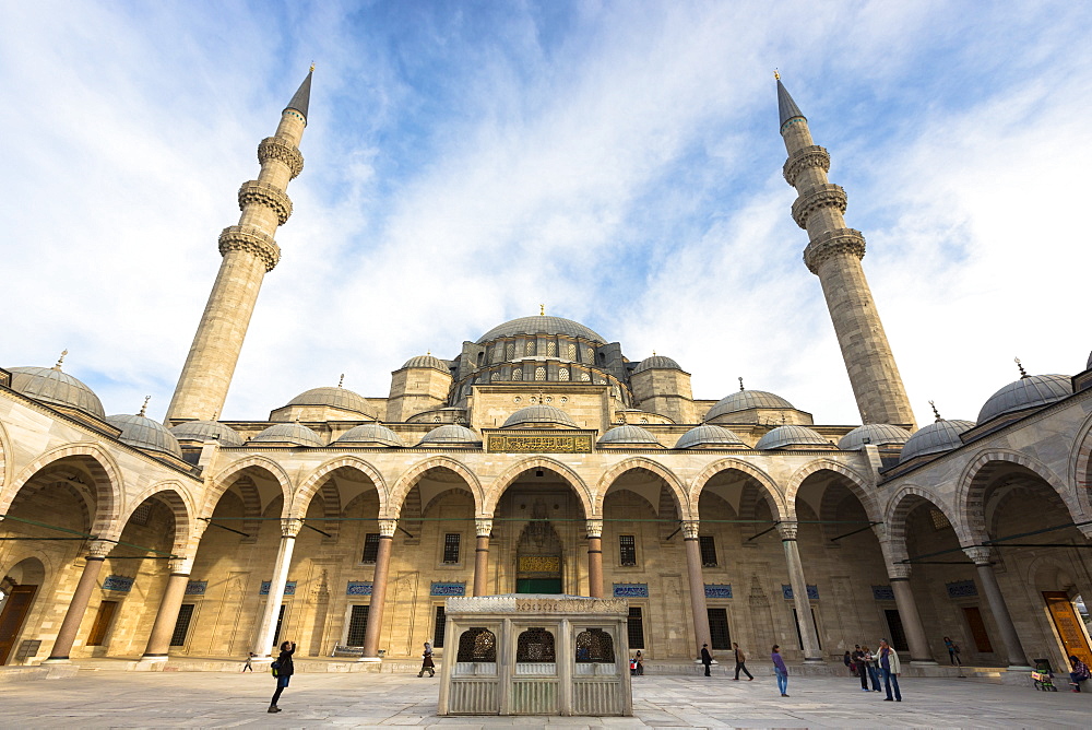 Tourists in colonnade courtyard of Suleymaniye Mosque, UNESCO World Heritage Site, Istanbul, Turkey, Europe