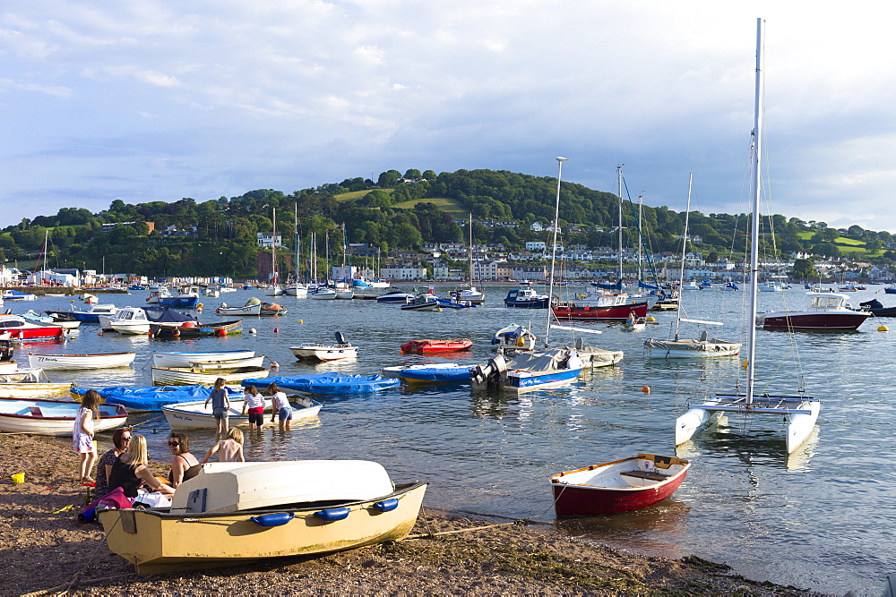 Boats in the harbour and family group on beach at coastal resort of Teignmouth in South Devon, England, United Kingdom, Europe