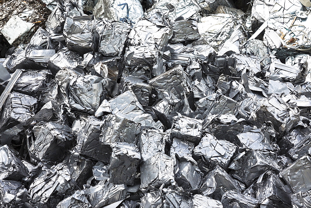 Recycling scrap metal dealer, dealing in ferrous and non-ferrous metals, compacted into cubes to stop environmental pollution, England, United Kingdom, Europe