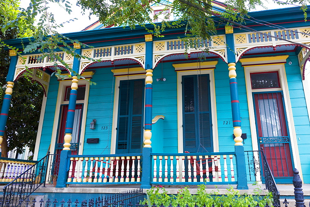 Traditional bright clapboard creole cottage home with front stoop in Faubourg Marigny historic district  of New Orleans, USA