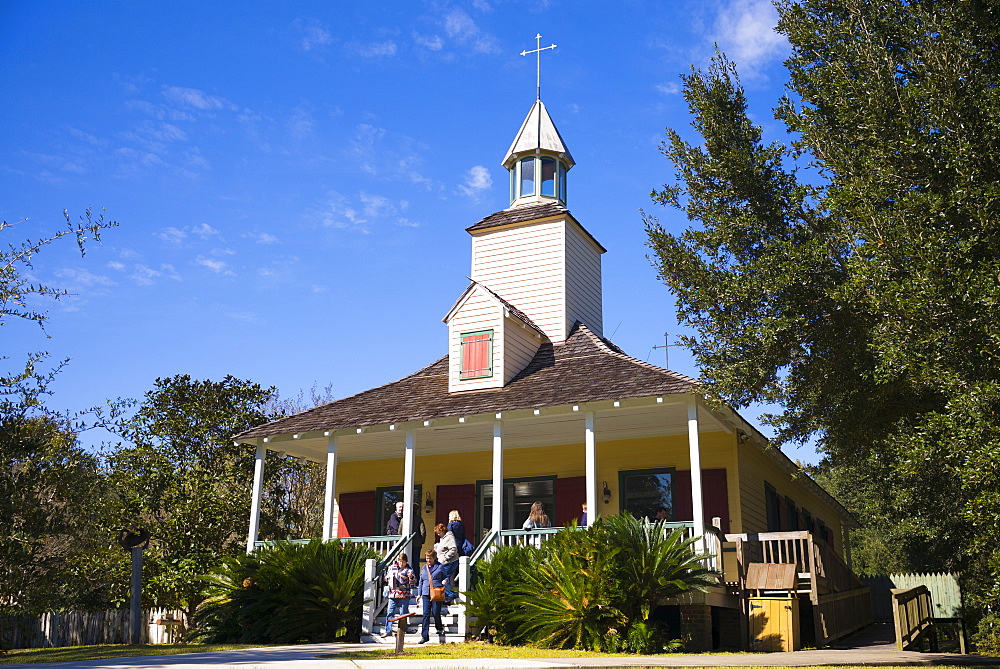 Tourists at Church at Vermilionville living history museum of Acadian (Cajun), Creole and Native American culture, Louisiana USA