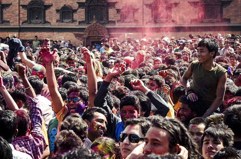 A crowd gathers in Basantapur Durbar Square to celebrate the Holi festival, Kathmandu, Nepal, Asia 