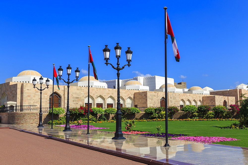 Polished pavements, National Flags, lush lawns and flowers in bloom, Sultan's Palace, Old Muscat, Oman, Middle East