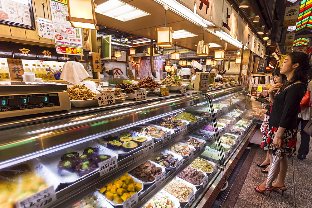 Customers wait at counter of local Japanese food stall, Nishiki Market (Kyoto's Kitchen), Downtown Kyoto, Japan, Asia